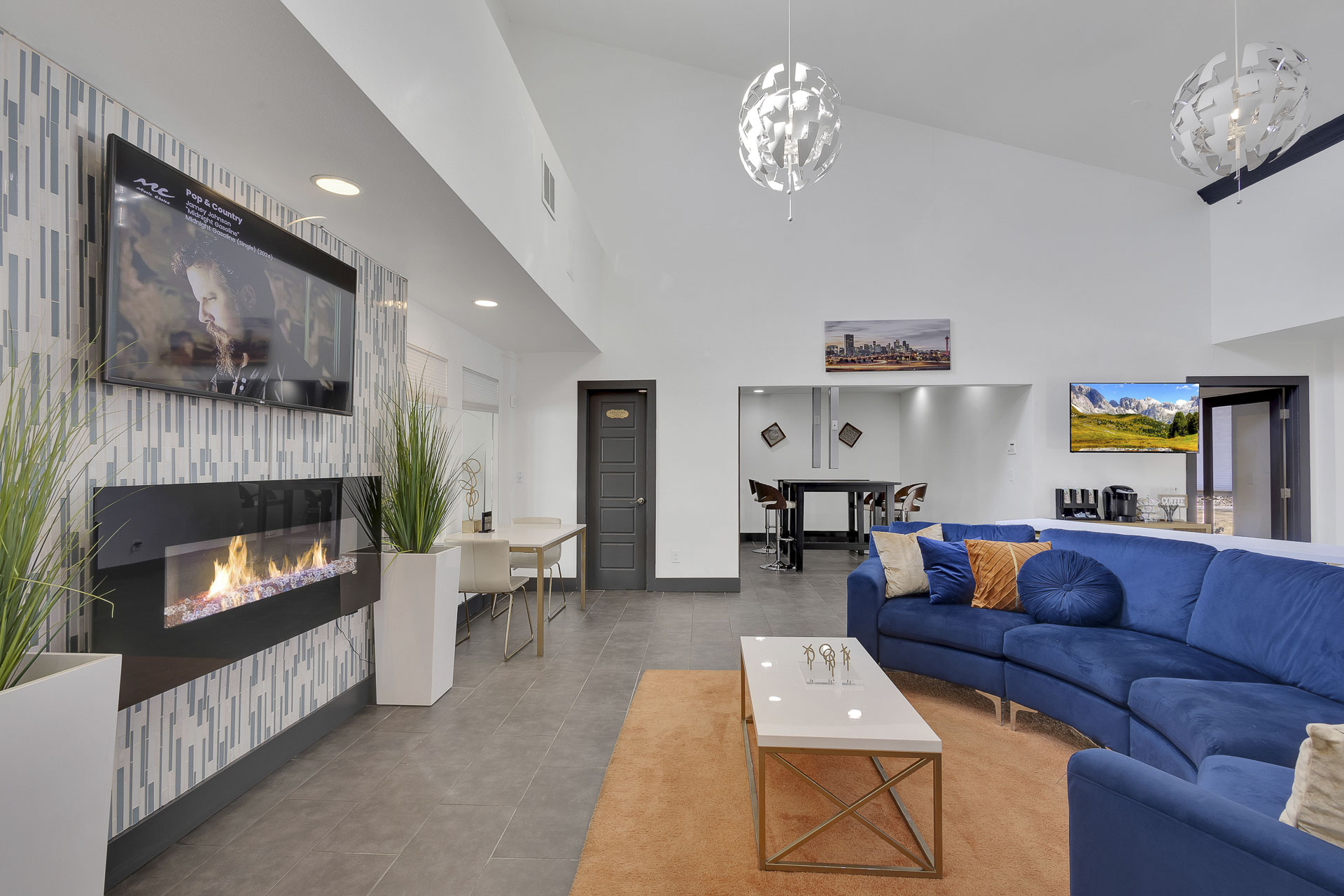 Club house with sofa, fireplace and office area