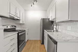 a kitchen with white cabinets and white counter tops