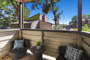 a patio with chairs and a table