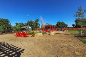 a red chairs in a dirt area